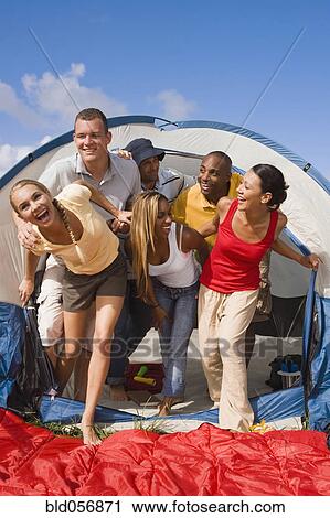 Multi-ethnic friends exiting tent View Large Photo Image Stock Image - Multi-ethnic friends exiting tent. Fotosearch