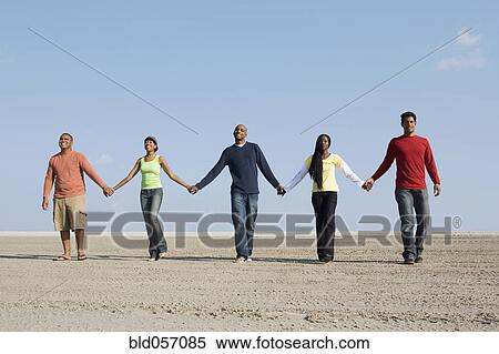 Multi-ethnic friends holding hands View Large Photo Image Stock Photography - Multi-ethnic friends holding hands. Fotosearch
