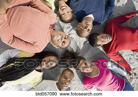 Multi-ethnic friends laying in circle View Large Photo Image Stock Image - Multi-ethnic friends laying in circle. Fotosearch