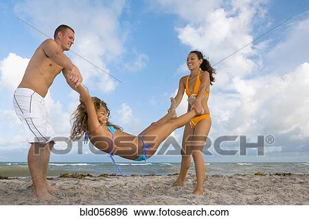 Multi-ethnic friends playing at beach View Large Photo Image Stock Photograph - Multi-ethnic friends playing at beach. Fotosearch