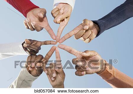 Picture - Multi-ethnic friends pointing fingers in circle. Fotosearch