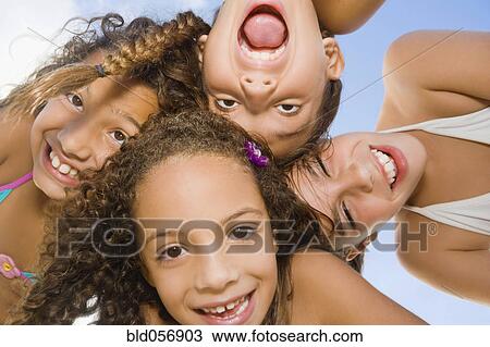 Stock Image - Multi-ethnic girls making faces. Fotosearch