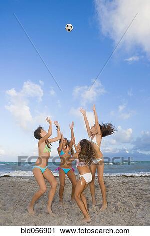 Multi-ethnic girls playing with soccer ball at beach View Large Photo Image Stock Image - Multi-ethnic girls playing with soccer ball at beach. Fotosearch