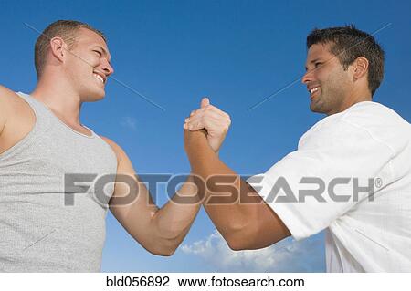 Multi-ethnic men clasping hands View Large Photo Image Stock Image - Multi-ethnic men clasping hands. Fotosearch
