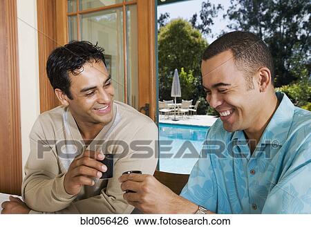 Multi-ethnic men toasting with sake View Large Photo Image Stock Photograph - Multi-ethnic men toasting with sake. Fotosearch
