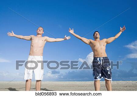 Multi-ethnic men with arms outstretched View Large Photo Image Stock Image - Multi-ethnic men with arms outstretched. Fotosearch