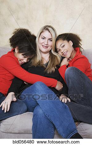 Multi-ethnic mother and twin daughters hugging View Large Photo Image Stock Image - Multi-ethnic mother and twin daughters hugging. Fotosearch