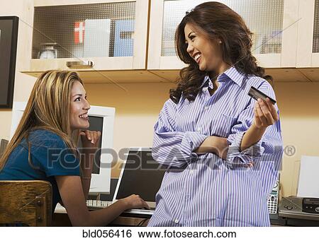 Multi-ethnic women shopping online View Large Photo Image Stock Photograph - Multi-ethnic women shopping online. Fotosearch