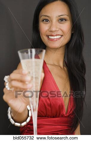 Pacific Islander woman holding champagne View Large Photo Image Stock Image - Pacific Islander woman holding champagne. Fotosearch