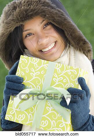 Pacific Islander woman holding gift View Large Photo Image Stock Photo - Pacific Islander woman holding gift. Fotosearch