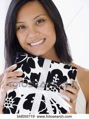 Pacific Islander woman holding gift View Large Photo Image Stock Photo - Pacific Islander woman holding gift. Fotosearch