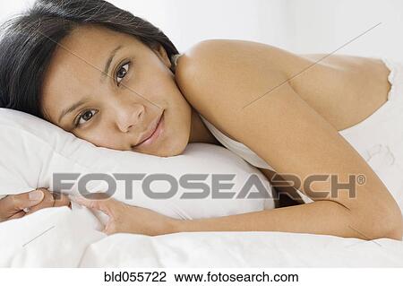 Pacific Islander woman laying on bed View Large Photo Image Stock Image - Pacific Islander woman laying on bed. Fotosearch