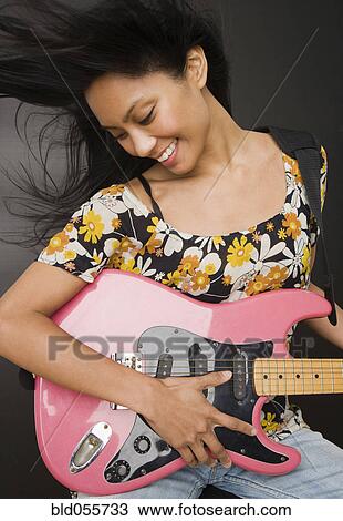 Pacific Islander woman playing electric guitar View Large Photo Image Stock Image - Pacific Islander woman playing electric guitar. Fotosearch