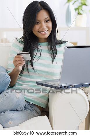 Stock Image - Pacific Islander woman shopping online. Fotosearch