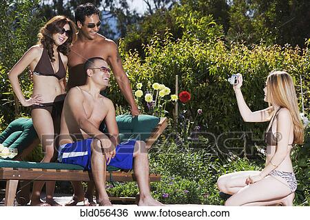 Pacific Islander woman taking photograph of friends View Large Photo Image Stock Photograph - Pacific Islander woman taking photograph of friends. Fotosearch