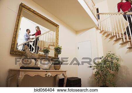 Picture - Reflection of Multi-ethnic couple on stairs. Fotosearch