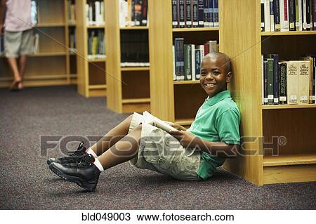 African American boy holding library book View Large Photo Image Stock Image - African American boy holding library book. Fotosearch
