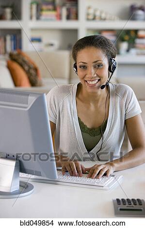 Picture - African American businesswoman wearing headset. Fotosearch
