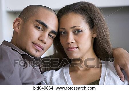 Picture - African American couple hugging. Fotosearch