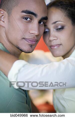 Stock Photograph - African American couple hugging. Fotosearch