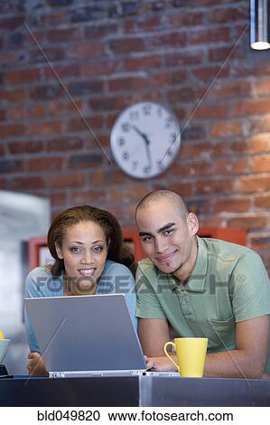 Stock Image - African American couple with laptop. Fotosearch