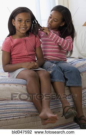 African American girl braiding sister’s hair View Large Photo Image Stock Image - African American girl braiding sister’s hair. Fotosearch