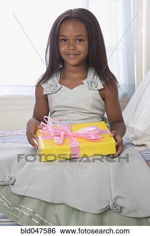 African American girl holding gift View Large Photo Image Stock Photograph - African American girl holding gift. Fotosearch
