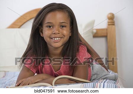 African American girl laying on bed View Large Photo Image Stock Image - African American girl laying on bed. Fotosearch