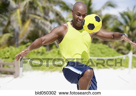 African American man bouncing soccer ball on knee View Large Photo Image Stock Image - African American man bouncing soccer ball on knee. Fotosearch