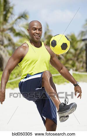 African American man bouncing soccer ball on knee View Large Photo Image Stock Photography - African American man bouncing soccer ball on knee. Fotosearch