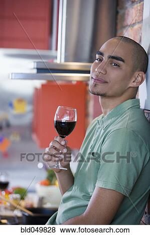 Stock Photo - African American man drinking wine. Fotosearch