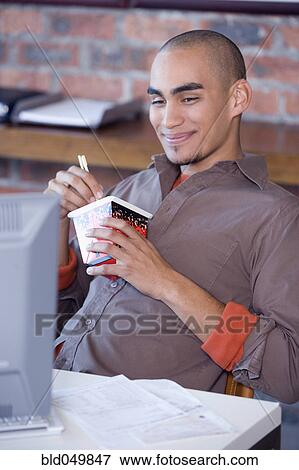 African American man eating take out food View Large Photo Image Stock Photo - African American man eating take out food. Fotosearch
