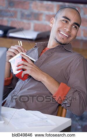 African American man eating take out food View Large Photo Image Stock Photograph - African American man eating take out food. Fotosearch