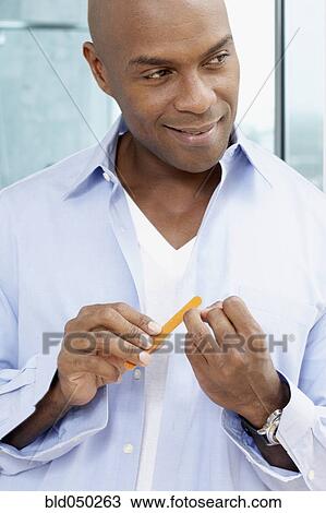 African American man filing fingernails View Large Photo Image Stock Image - African American man filing fingernails. Fotosearch