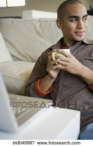 African American man holding coffee mug View Large Photo Image Stock Photo - African American man holding coffee mug. Fotosearch