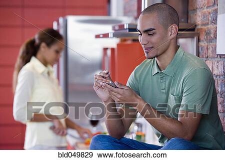 Stock Photo - African American man holding electronic organizer. Fotosearch