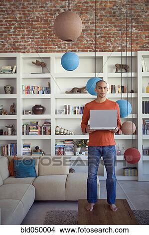 African American man holding laptop View Large Photo Image Picture - African American man holding laptop. Fotosearch