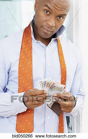 African American man holding money View Large Photo Image Stock Photograph - African American man holding money. Fotosearch