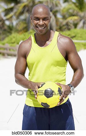 African American man holding soccer ball View Large Photo Image Stock Photograph - African American man holding soccer ball. Fotosearch