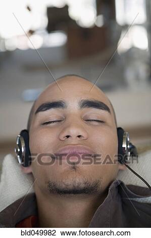 African American man listening to headphones View Large Photo Image Stock Image - African American man listening to headphones. Fotosearch