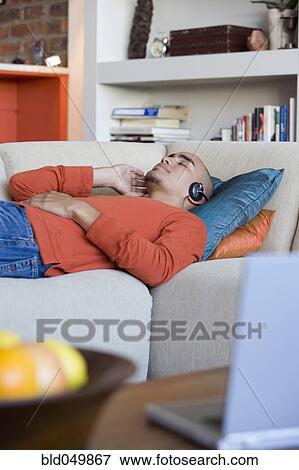 African American man listening to headphones View Large Photo Image Stock Photo - African American man listening to headphones. Fotosearch