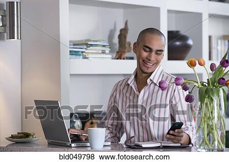 African American man looking at cell phone View Large Photo Image Stock Photo - African American man looking at cell phone. Fotosearch
