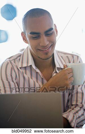 African American man looking at laptop View Large Photo Image Stock Image - African American man looking at laptop. Fotosearch