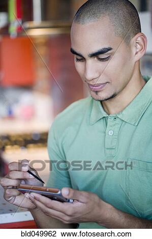 African American man looking at electronic organizer View Large Photo Image Stock Image - African American man looking at electronic organizer. Fotosearch