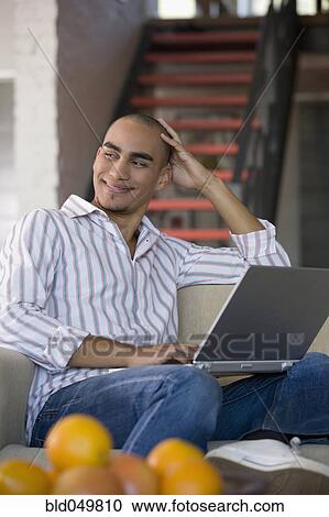 Stock Image - African American man looking to side. Fotosearch
