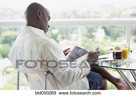 African American man reading magazine View Large Photo Image Stock Photo - African American man reading magazine. Fotosearch