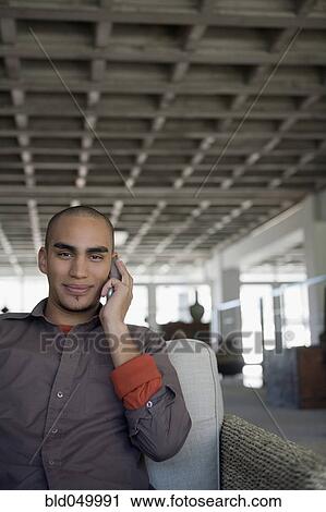 Stock Image - African American man taking on cell phone. Fotosearch