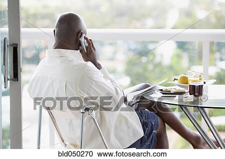 Stock Image - African American man talking on telephone. Fotosearch