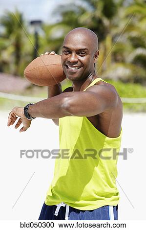 African American man throwing football View Large Photo Image Stock Image - African American man throwing football. Fotosearch