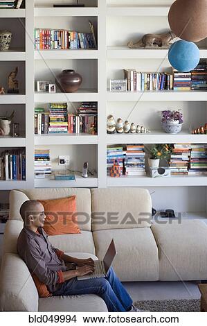 Picture - African American man typing on laptop. Fotosearch
